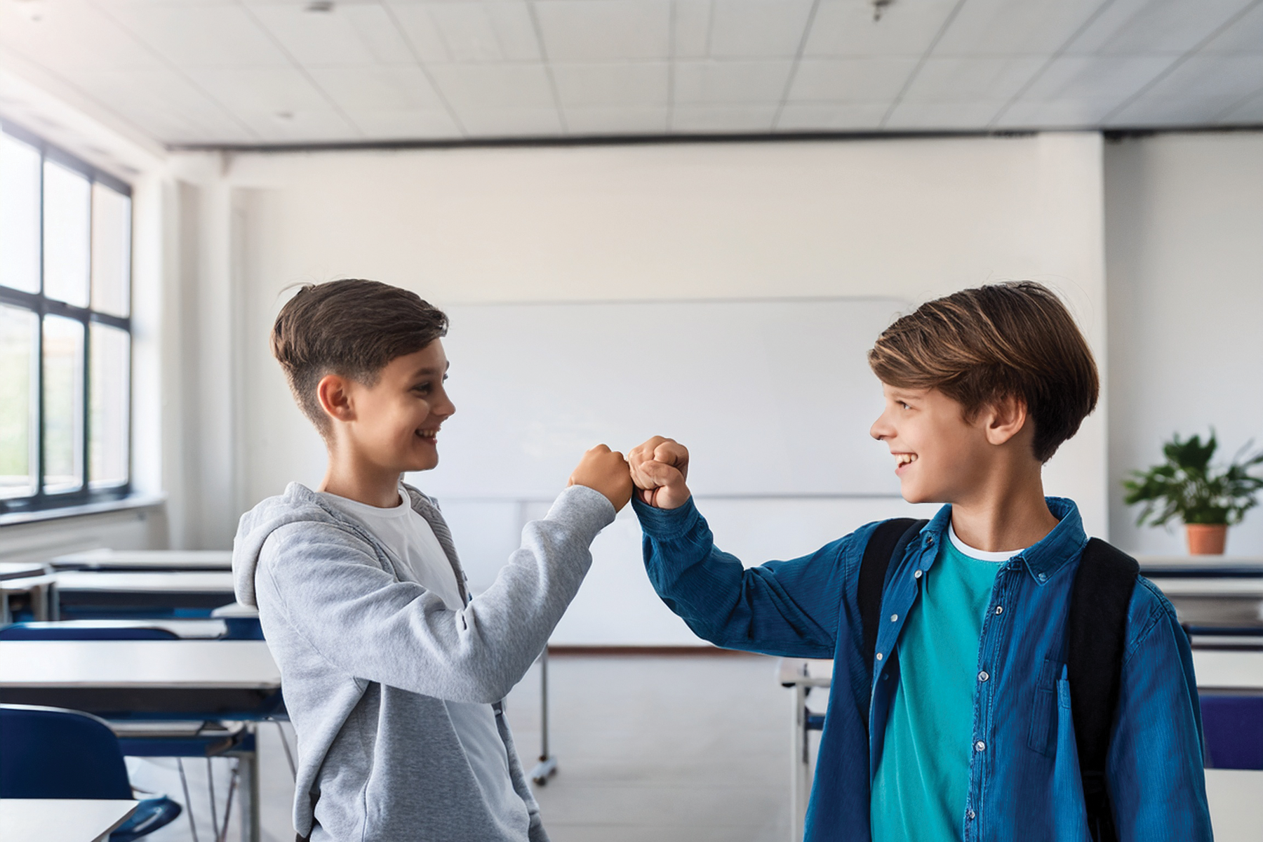 Fistbump in white classroom